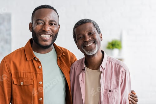 Preview: Positive african american man hugging father and looking at camera at home