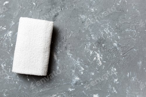 Preview: Top view of white towels with copy space on colored background
