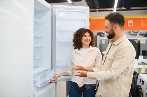 Preview: Couple choosing refrigerator in electronics store