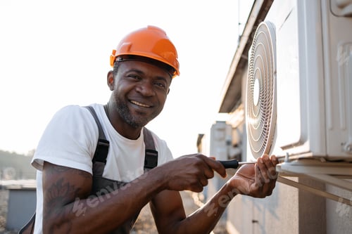 Preview: Craftsman repairing air conditioner with screwdriver on roof