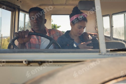 Preview: Couple sitting in car at countryside