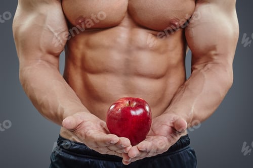 Preview: Six pack torso and red apple in hands