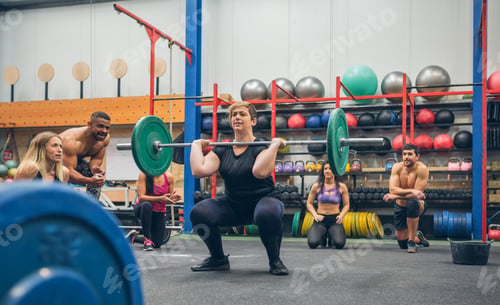Preview: Woman weightlifting while her gym mates cheering her on