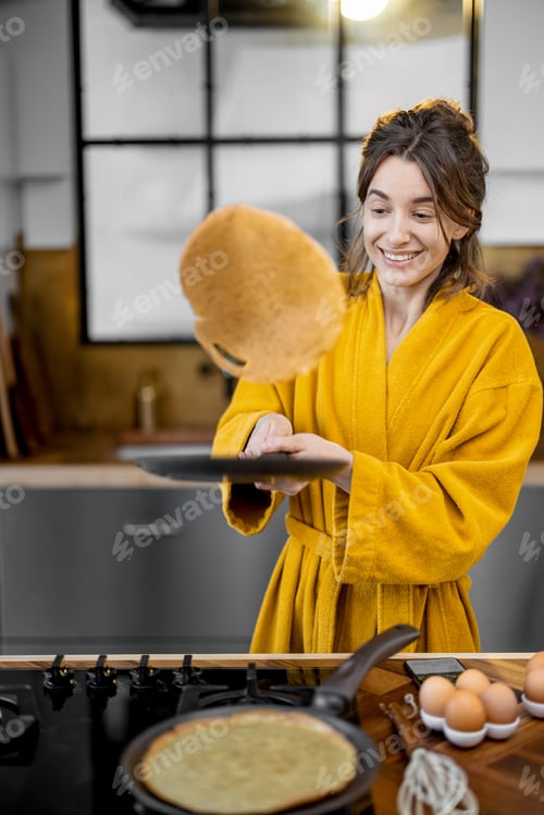 Preview: Woman cooks pancakes for breakfast