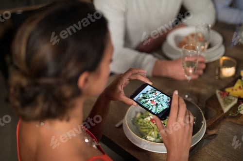 Preview: Woman taking photo of meal with mobile phone