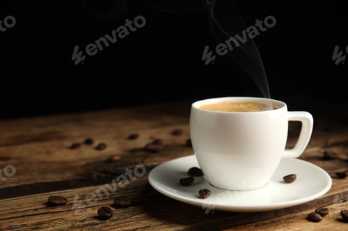 Preview: Cup of tasty coffee and beans on wooden table, space for text