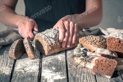 Preview: baker holding fresh bread in hands