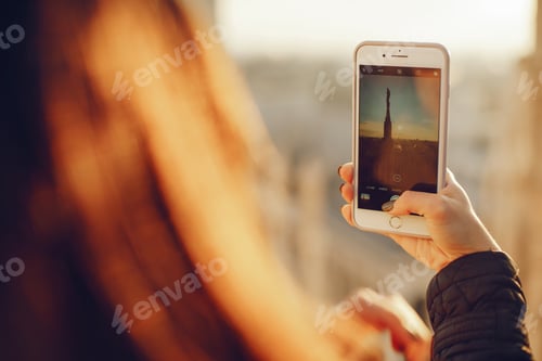 Preview: girl using her phone while exploring Milan Italy