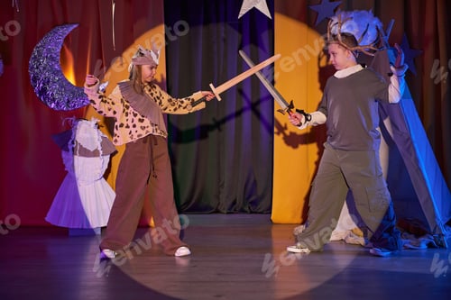 Preview: Two Kids Acting out Knights Battle on Stage of Inclusive Childrens Theater