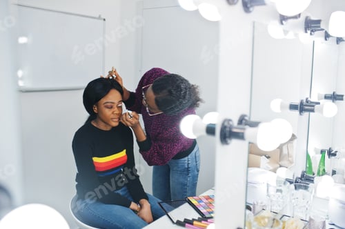 Preview: African American woman applying make-up