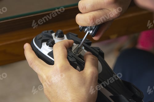 Preview: Closeup shot of a male assembling his cycling carbon road shoes and attaching cleats for pedals