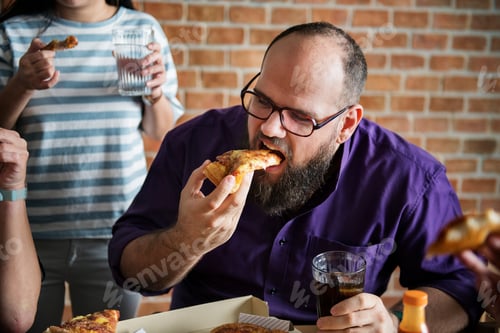 Preview: Friends eating pizza together at home