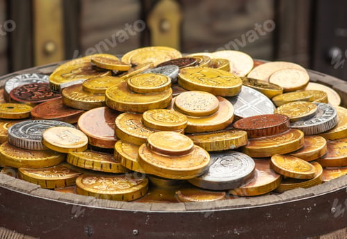 Preview: A lot of gold coins on a wooden barrel