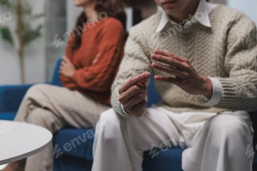 Preview: Man holding wedding ring, facing relationship problems