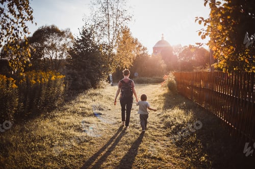 Preview: Adult and Child Walk Hand-in-Hand in Rural Setting
