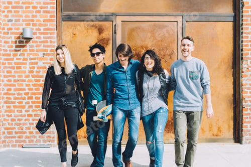 Preview: Group of young multiethnic friends walking down the street