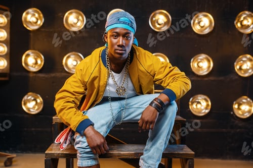 Preview: Black rapper in cap sitting on the steps