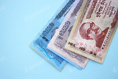 Preview: Bangladeshi taka money bills in big amount lies on teal color table close up