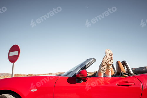 Preview: Woman traveling on converrtible sports car