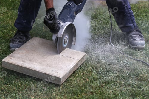 Preview: Construction worker using a professional angle grinder