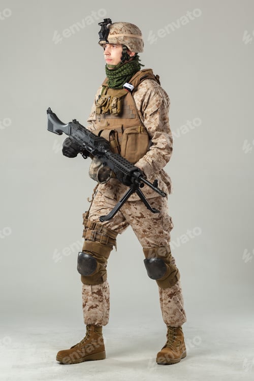 Preview: Soldier in desert camouflage gear stands ready for duty with firearm in hand