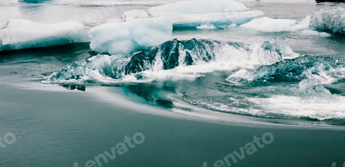 Preview: Glacial river and blue icebergs on Jokulsarlon glacier lake. Vatnajokull National Park, Iceland.