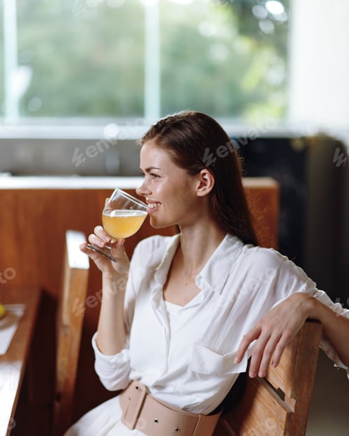 Preview: Romantic Dinner at Home Smiling Woman Enjoying a Homemade Meal and Celebrating Beautifully Decorated