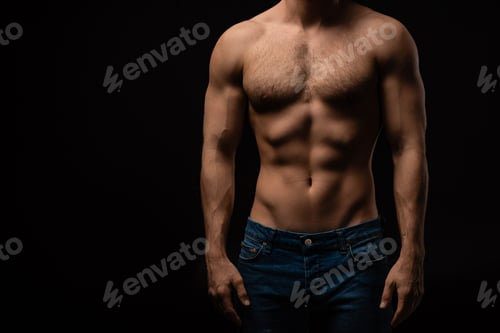 Preview: cropped view of sexy man in jeans with bare muscular torso isolated on black