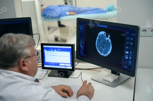 Preview: Elderly doctor performs MRI diagnostics of brain in modern clinic