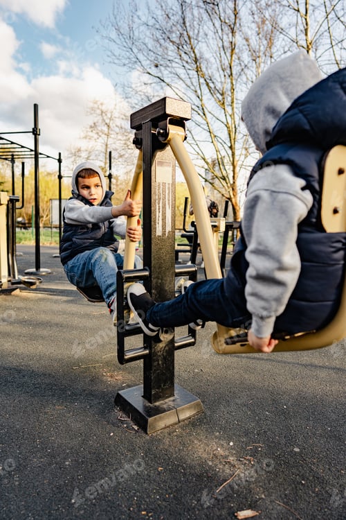 Preview: Two young boys playing on sports ground in the park
