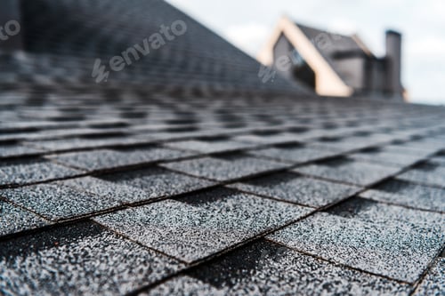 Preview: selective focus of grey shingles on rooftop of building