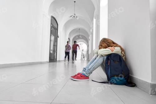 Preview: Sad schoolgirl sitting on floor, crying