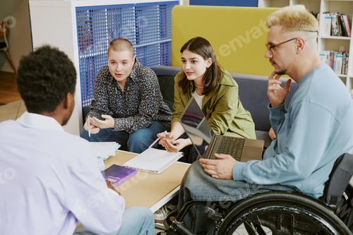 Preview: Discussing Group Assignment at Study Table in Library