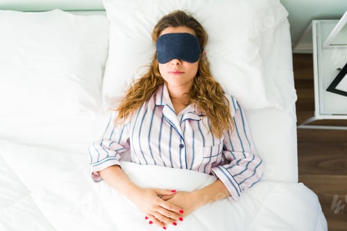 Preview: Top view of a tired woman sleeping with a mask