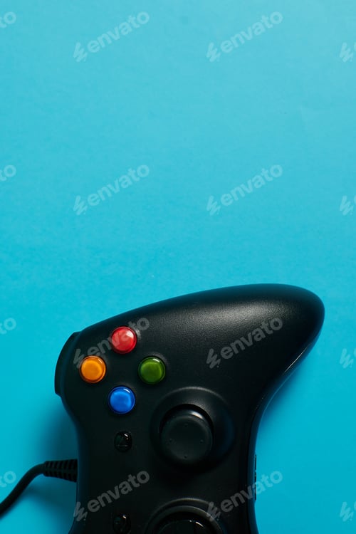 Preview: Close-up video game console controller on a blue background