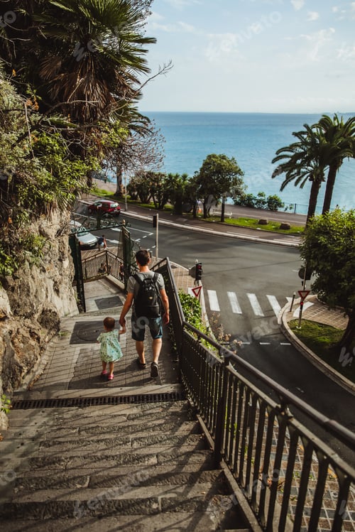 Preview: Father and daughter go down the stairs from the observation deck in Castle Hill or Colline du