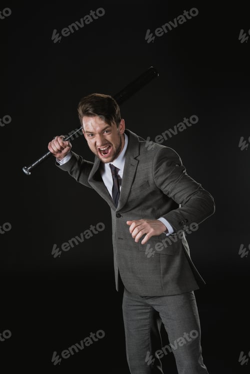Preview: Angry businessman holding baseball bat and screaming isolated on black