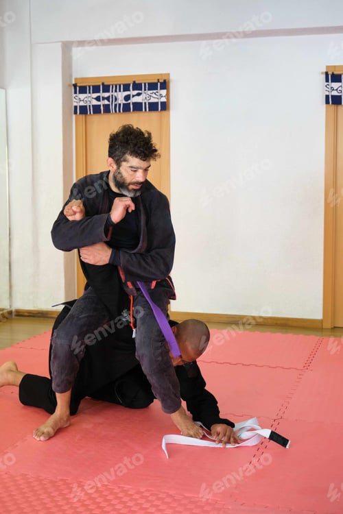 Preview: Two men practicing Brazilian Jiu-Jitsu fighting at the School.