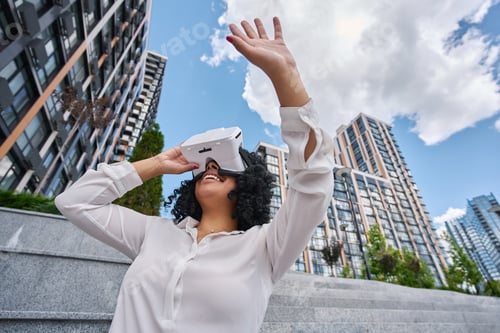 Preview: Multiracial woman outdoors wearing virtual reality glasses