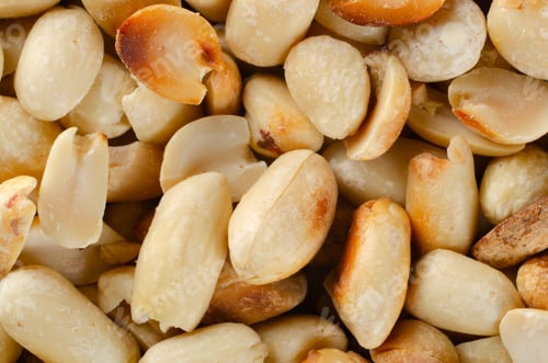 Preview: Flat lay view at roasted peanuts background closeup shot. Healthy eating concept