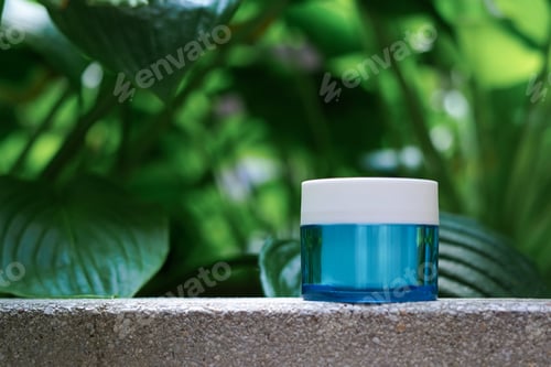 Preview: blue jar with cosmetic cream staying on the stone on natural background in the forest