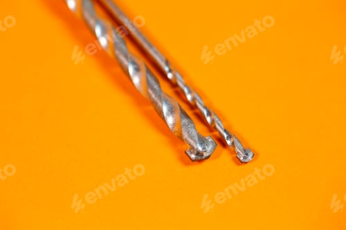 Preview: Drills for metal of different sizes for a drill on an orange background. Building tool