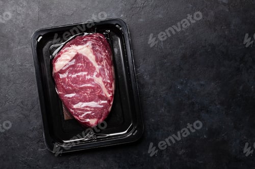 Preview: Vacuum packed beef steak. Raw ribeye steak