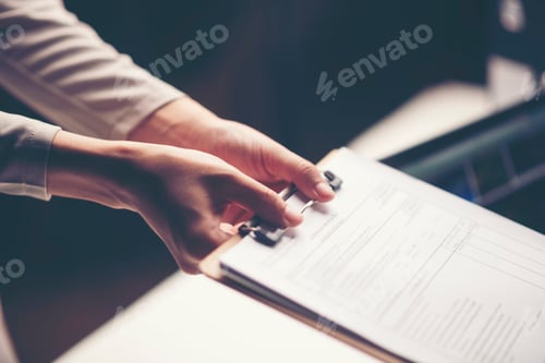 Preview: business document in hand of businessman