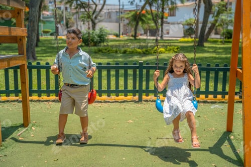 Preview: Latin siblings swinging in a park after school