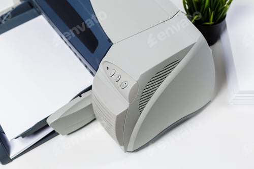 Preview: Printer with papers and a small plant on a desk in a workspace setting