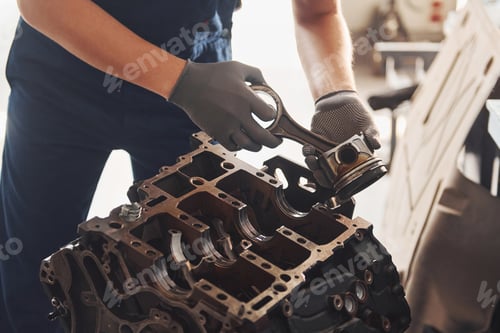 Preview: Professional repairman works with broken automobile engine