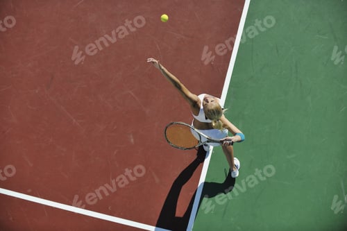 Preview: Young Fit Woman Play Tennis Outdoor On Orange Tennis Field At Early Morning