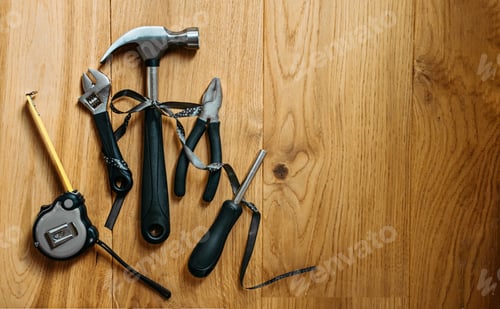 Preview: Happy labor day banner with different construction tools on wooden background. Construction and