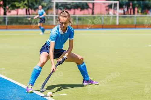 Preview: Young woman field hockey player performing corner penalty